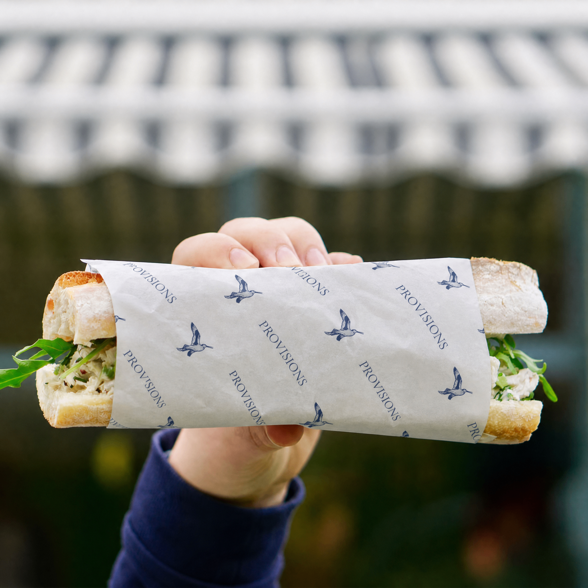 Provisions sandwich wrapped in branded deli paper